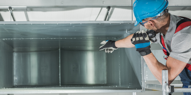 Maintenance worker in elevator shaft doing world-class maintenance